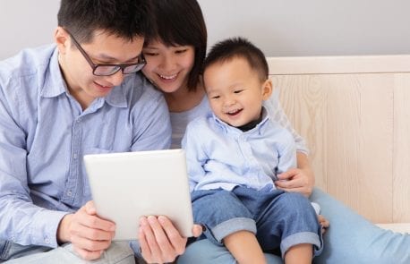 asian couple showing they happy baby an ipad